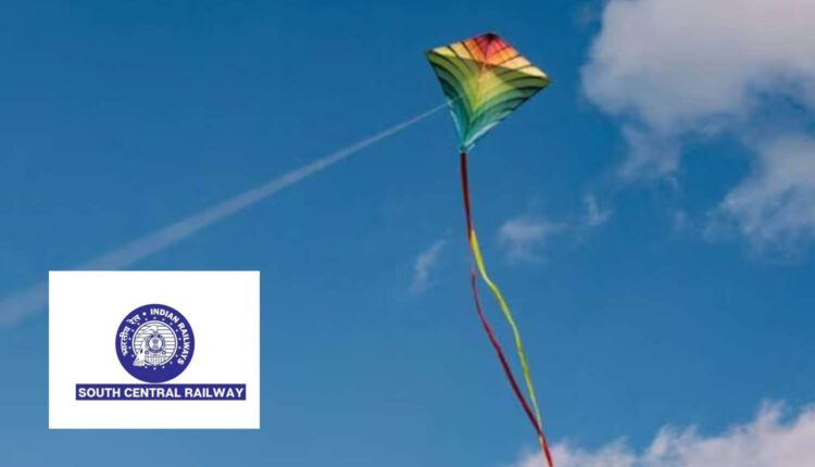 kite flying near railway tracks